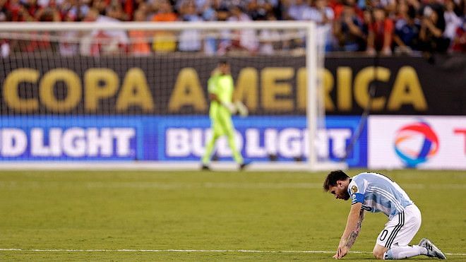 Lionel Messi sinks to the turf after missing his spot-kick in the 2016 Copa America final
