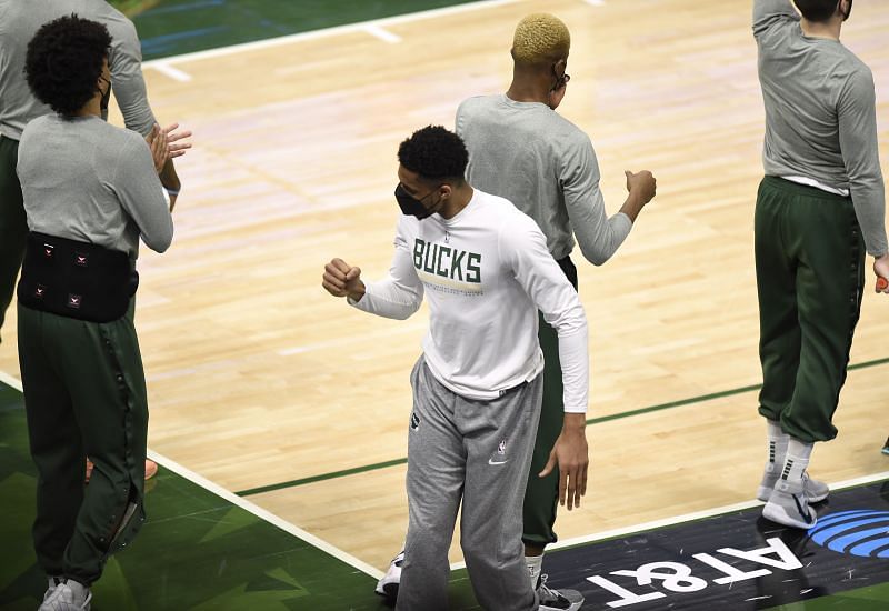 Giannis Antetokounmpo of the Milwaukee Bucks cheering his team from the bench.