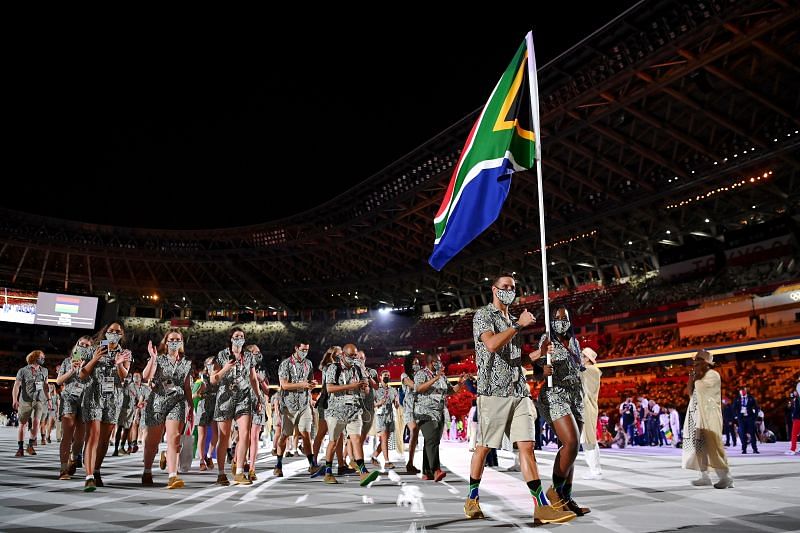 Flag bearers Phumelela Luphumlo Mbande and Chad Le Clos of Team South Africa lead their team out during the Opening Ceremony of the Tokyo 2020 Olympic Games