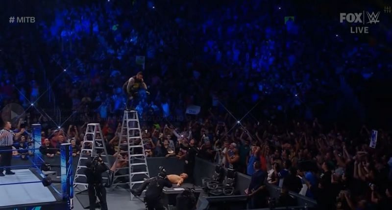 Kevin Owens jumps off the ladder