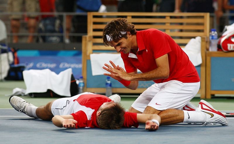 Stan Wawrinka and Roger Federer celebrate after winning gold in Beijing