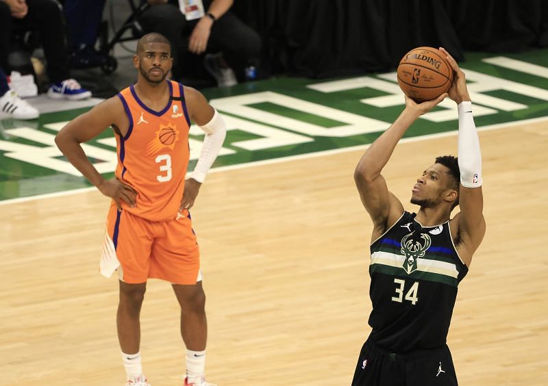 Giannis Antetokounmpo #34 shoots a free throw as Chris Paul #3 of the Phoenix Suns watches.