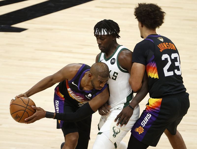 The Phoenix Suns&#039; Chris Paul #3 is pressured by the Milwaukee Bucks&#039; Jrue Holiday #21