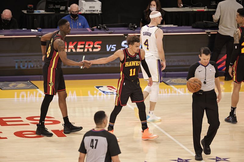 Trae Young (#11) of the Atlanta Hawks celebrates with Tony Snell (#19)