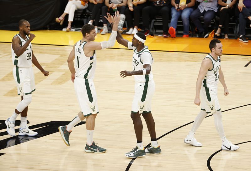 Brook Lopez #11 and Bobby Portis #9 of the Milwaukee Bucks celebrate against the Phoenix Suns