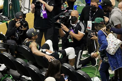 Giannis Antetokounmpo #34 of the Milwaukee Bucks sits on the bench for a moment after defeating the Phoenix Suns in Game Six to win the 2021 NBA Finals.