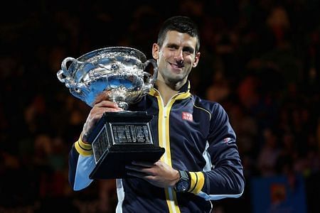 Novak Djokovic hoists aloft the 2013 Australian Open title.