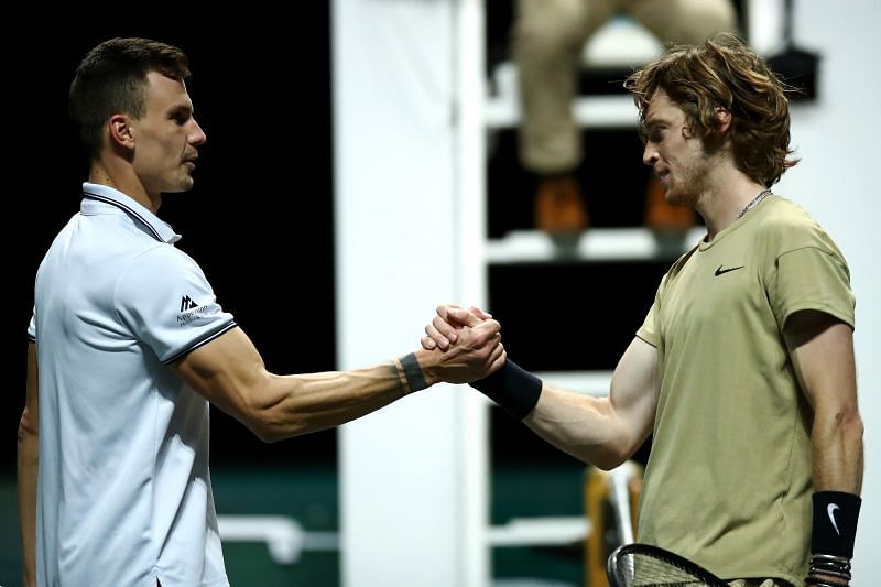 Marton Fucsovics (L) and Andrey Rublev shake hands after their match in Rotterdam