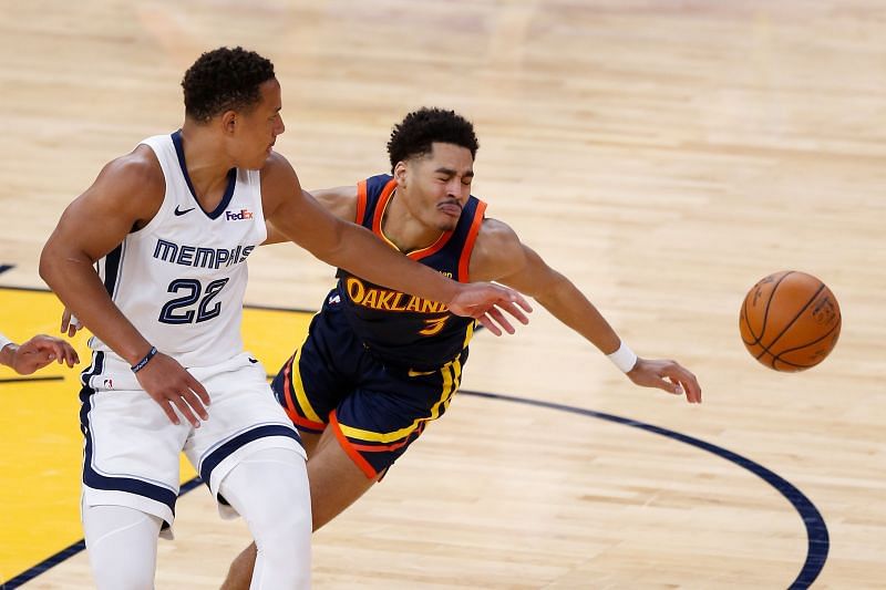 Jordan Poole #3 of the Golden State Warriors is fouled by Desmond Bane #22 of the Memphis Grizzlies.