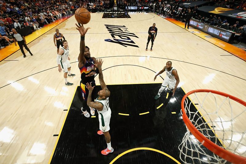 The Phoenix Suns&#039; Deandre Ayton #22 puts up a shot over the Milwaukee Bucks&#039; P.J. Tucker #17