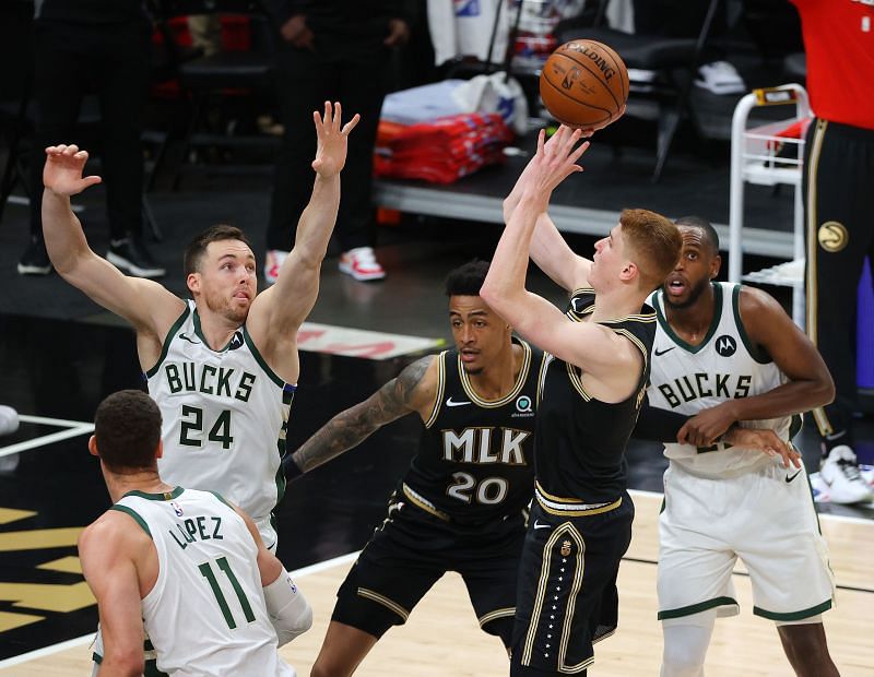 Kevin Huerter #3 shoots against Pat Connaughton #24.