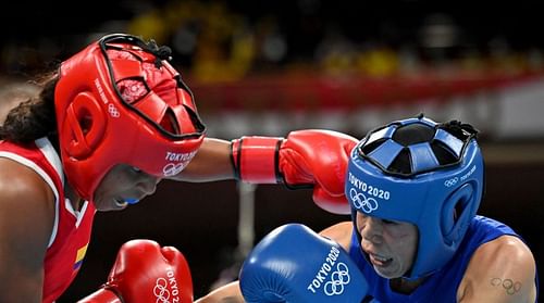 Mary Kom of Team India (in blue) exchanges punches with Ingrit Lorena Valencia Victoria ( in red) of Team Colombia during the Women's Fly (48-51kg)Boxing