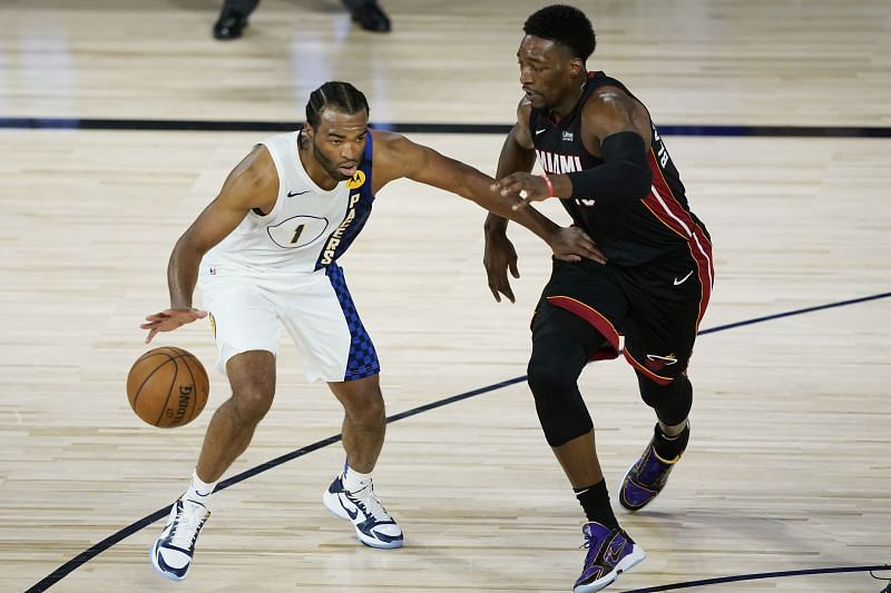 T.J. Warren #1 of the Indiana Pacers drives into Bam Adebayo #13 of the Miami Heat