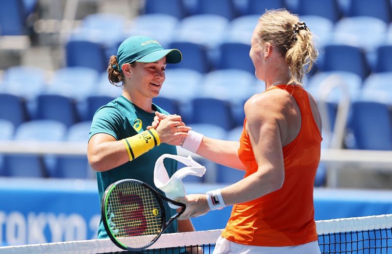Ashleigh Barty (L) shakes hands with Kiki Bertens after a practice session ahead of the Tokyo Olympics