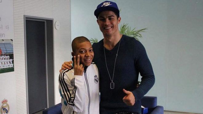 Cristiano Ronaldo with a young Kylian Mbappe (left)