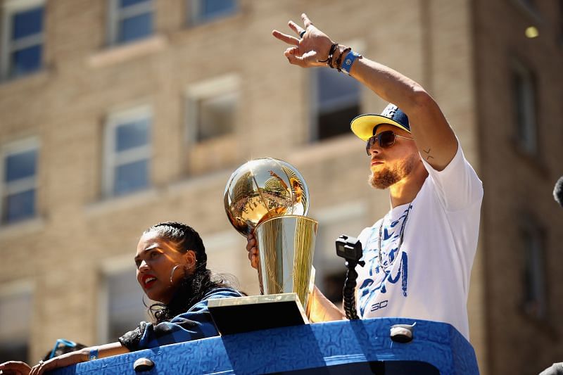 Stephen Curry #30 of the Golden State Warriors with the Larry O&#039;Brien trophy.
