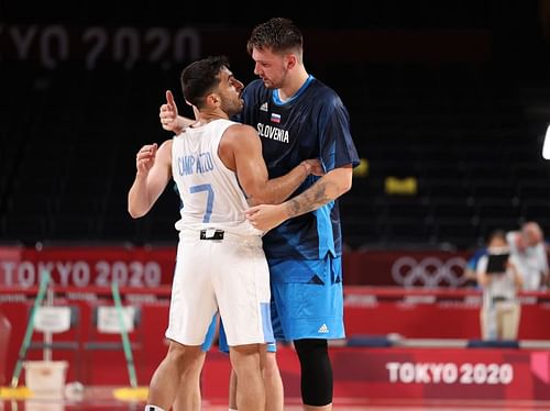 uka Doncic #77 of Team Slovenia embraces Facundo Campazzo #7 of Team Argentina.