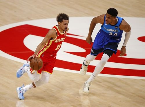 Trae Young drives against Giannis Antetokounmpo