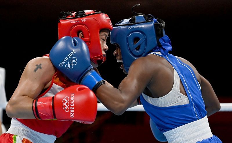 Mary Kom (in red) of India exchanges punches with Miguelina Hernandez Garcia (in blue) of the Dominican Republic during the Women&#039;s FlyBoxing