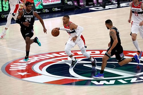 Russell Westbrook #4 dribbles the ball against Buddy Hield #24