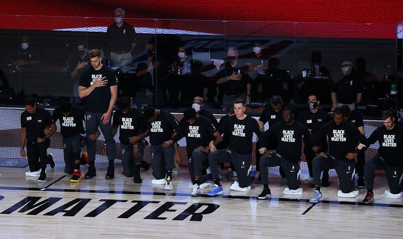 Meyers Leonard stands as the rest of the teams kneel during the national anthem