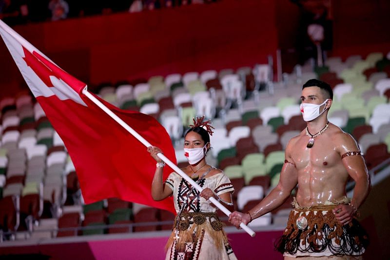 Flag bearers Malia Paseka and Pita Taufatofua of Team Tonga lead their team during the Opening Ceremony