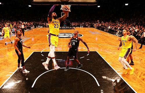 LeBron James #23 dunks against Rondae Hollis-Jefferson #24.