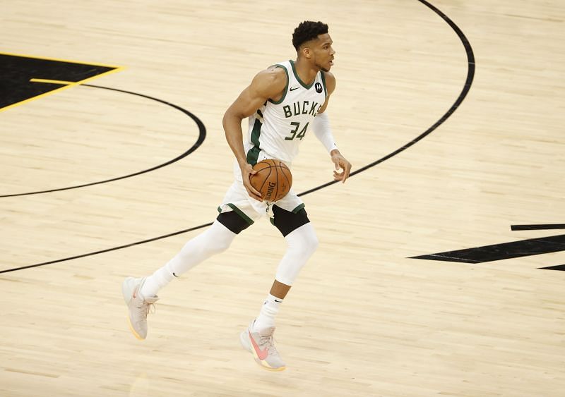 Giannis Antetokounmpo #34 brings the ball up court