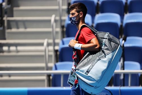 Novak Djokovic heads for a training session in Tokyo