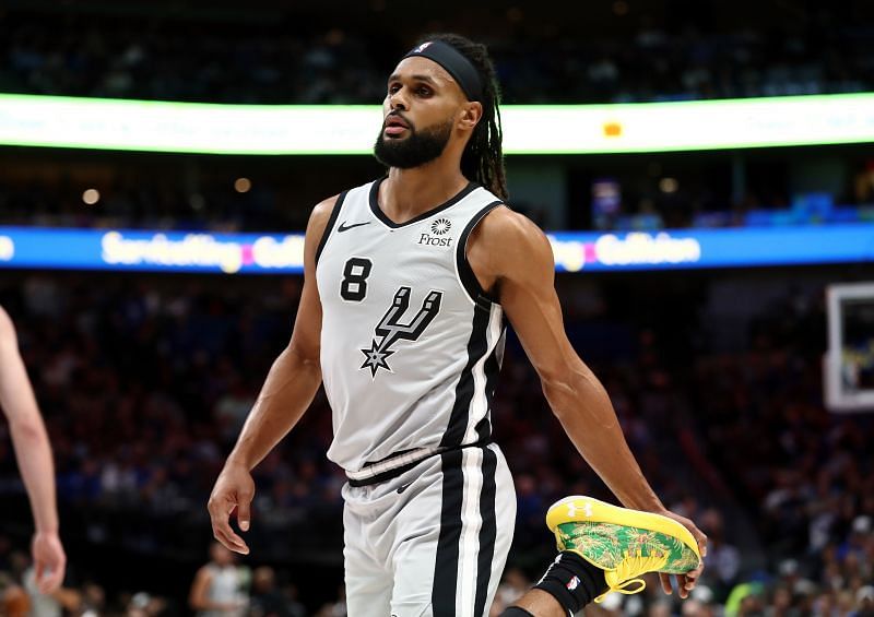 Patty Mills #8 stretches his legs on the court.