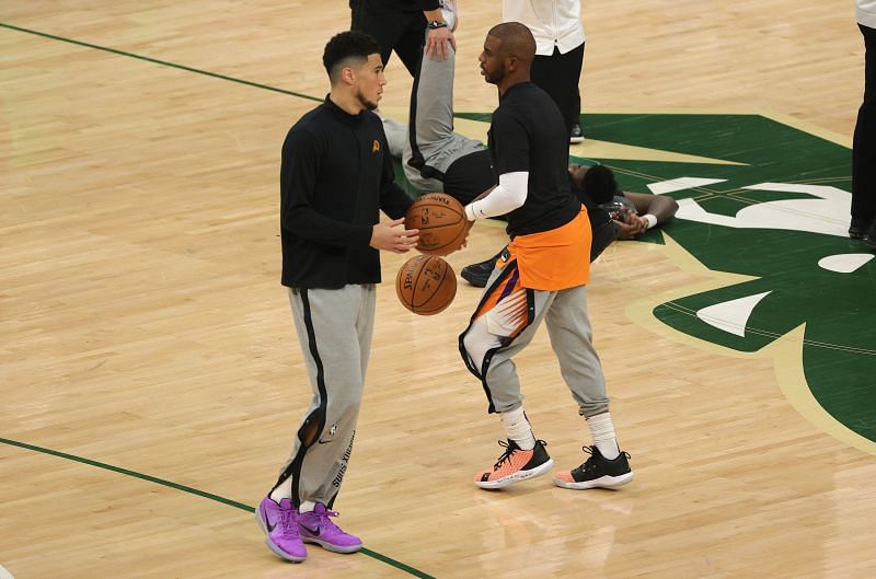 Devin Booker #1 and Chris Paul #3 warm up before Game 4