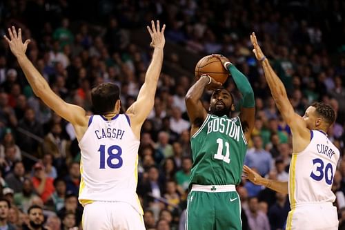 Kyrie Irving #11 guarded by Steph Curry #30 and Omri Casspi #18