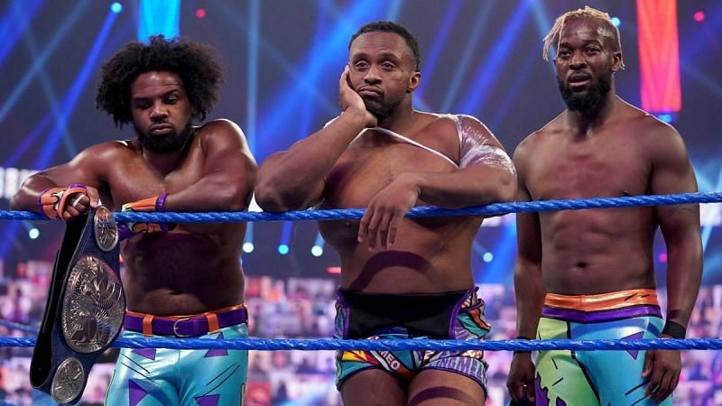 Xavier Woods (left) and Kofi Kingston (right) perform on RAW, while Big E (center) represents SmackDown