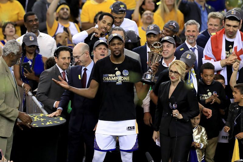 Kevin Durant #35 of the Golden State Warriors celebrates with the Bill Russell NBA Finals MVP Award.