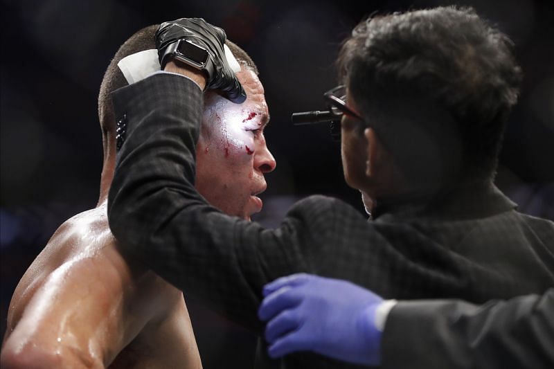 Nate Diaz being examined by the cageside doctor at UFC 244.