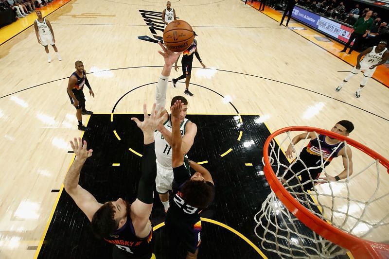 Brook Lopez #11 attempts a shot over Cameron Johnson #23 and Frank Kaminsky #8.