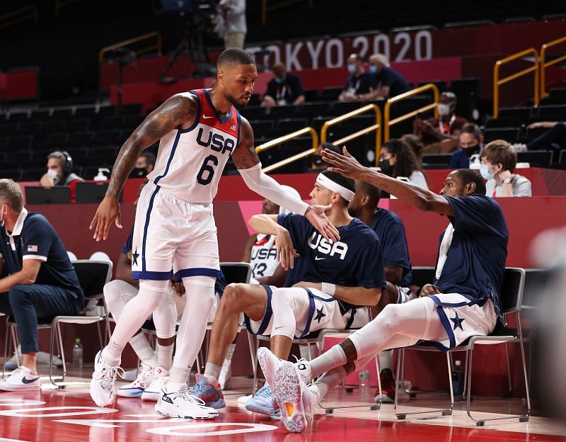 Damian Lillard #6 of Team United States high fives teammate Kevin Durant #7 as he makes his way to the bench