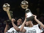 David Robinson and Tim Duncan celebrate after winning the NBA championship.