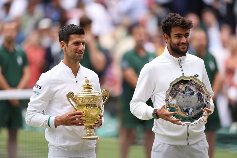 Novak Djokovic and Matteo Berrettini (R) pose during the trophy presentation ceremony