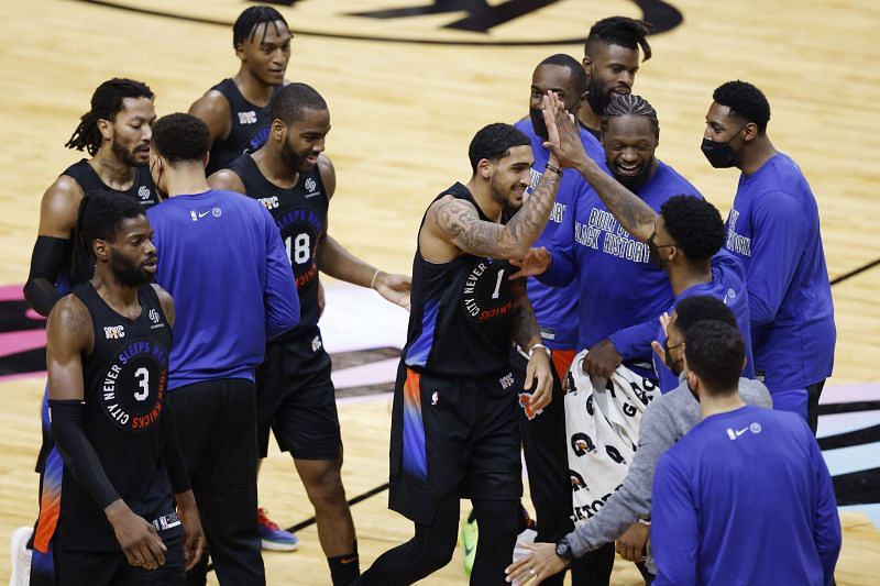 Knicks players celebrate a play