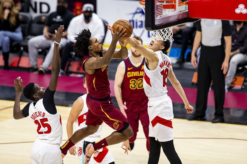 Collin Sexton #2 goes in for a layup as Yuta Watanabe #18 of the Toronto Raptors attempts to block him.