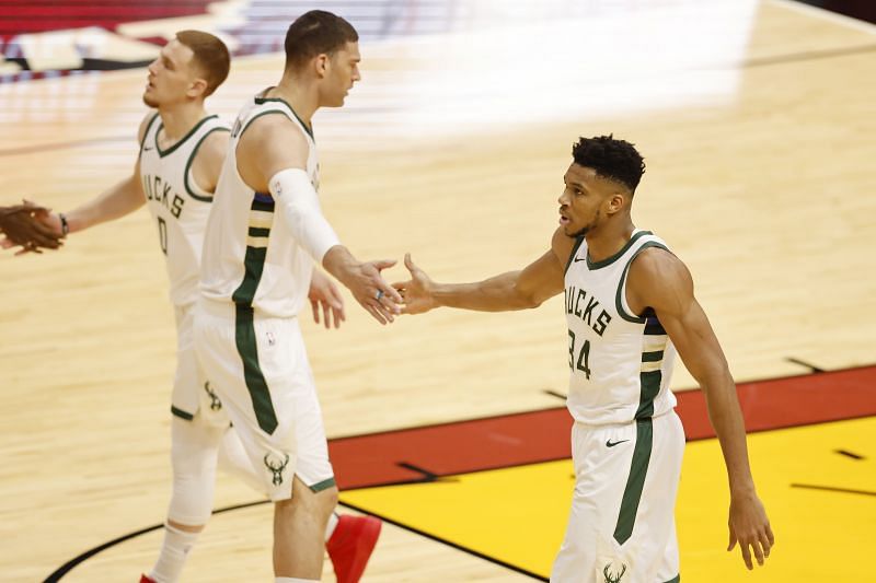 Giannis Antetokounmpo (#34) of the Milwaukee Bucks high fives Brook Lopez.