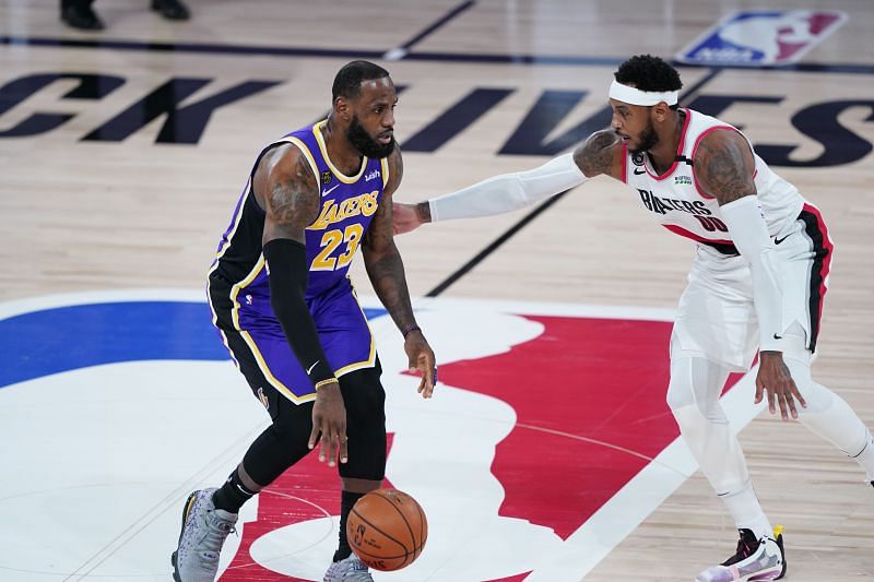 LeBron James #23 of the Los Angeles Lakers drives against Carmelo Anthony