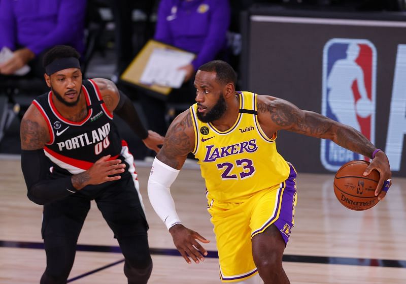 LeBron James #23 drives the ball against Carmelo Anthony #00.