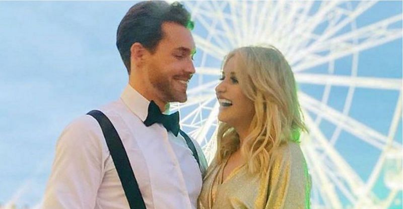 Sam Rason and Amy Hart stand in front of a ferris wheel (Image via Social Telecast)