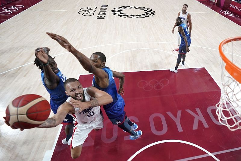 Evan Fournier #10 of Team France drives past Kevin Durant #7.