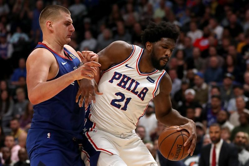 Nikola Jokic #15 of the Denver Nuggets guards Joel Embiid #21 of the Philadelphia 76ers.