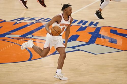 Immanuel Quickley #5 dribbles the ball in an NBA game.