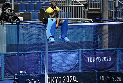 PR Sreejesh sitting on top of the goalpost after the win against Germany