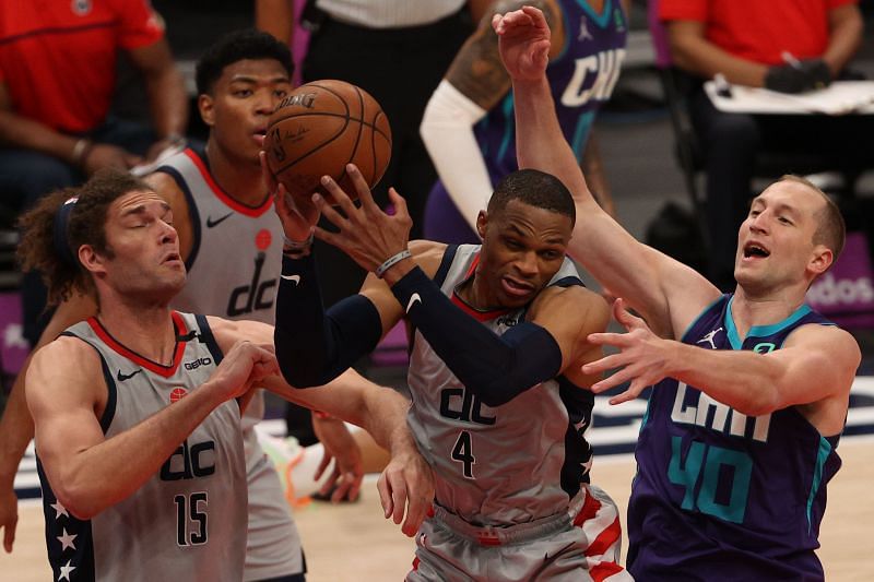 Russell Westbrook #4 grabs a rebound in front of Cody Zeller #40.